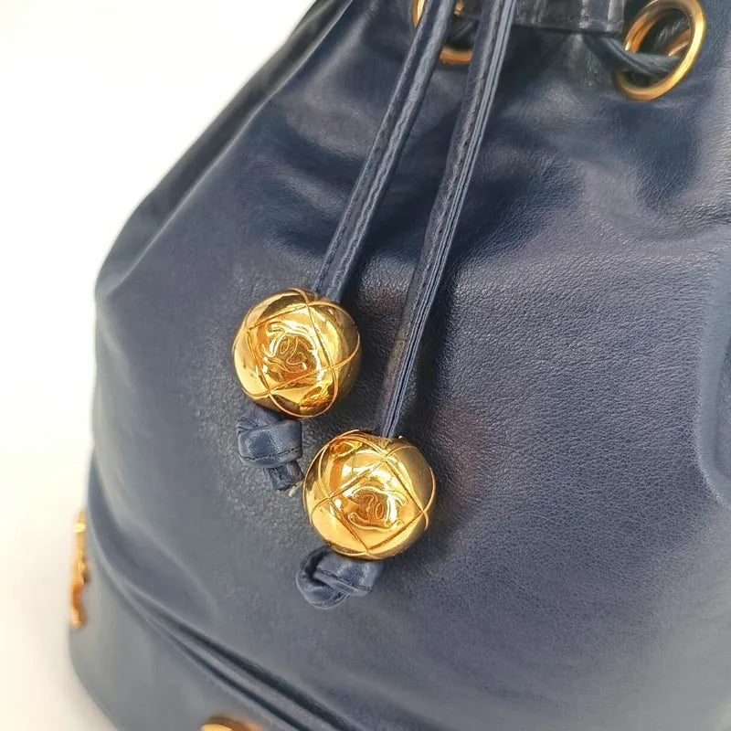 jah154-chanel-vintage-navy-lambskin-gold-ball-bucket-bag